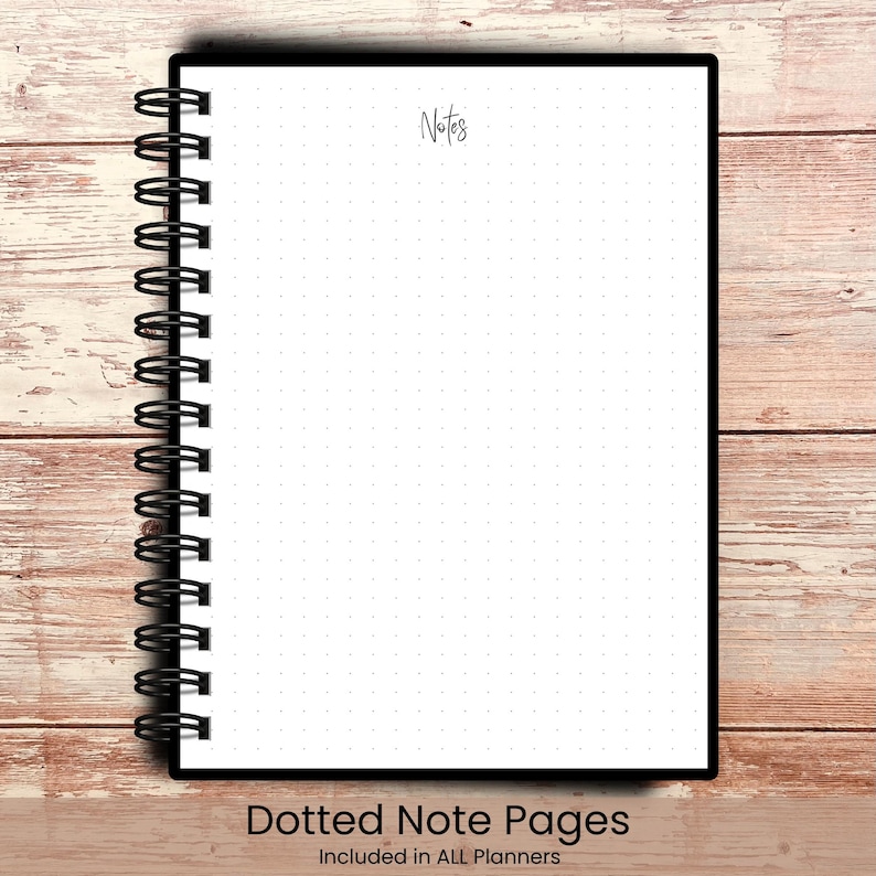 May include: A black spiral-bound notebook with white dotted pages. The word "Notes" is written in cursive at the top. The bottom of the notebook reads "Dotted Note Pages Included in ALL Planners". The notebook is on a wooden surface.