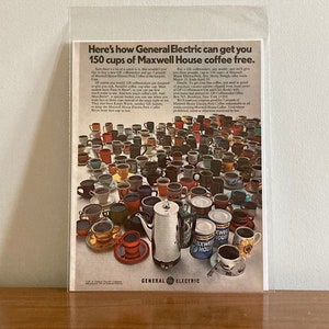 May include: A vintage advertisement for General Electric coffee makers. The ad features a large collection of colorful coffee mugs and a silver General Electric coffee pot. The text reads "Here's how General Electric can get you 150 cups of Maxwell House coffee free."