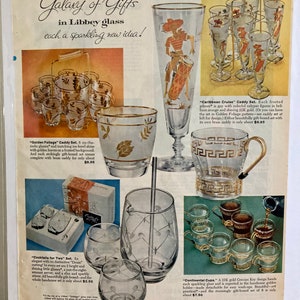 May include: A vintage advertisement for Libbey glass featuring a variety of glassware sets, including a set of cocktail glasses with a gold leaf design, a set of pilsner glasses with colorful figures, and a set of cups with a gold Grecian key design. The ad features the text "Galaxy of Gifts in Libbey glass, each a sparkling new idea!"