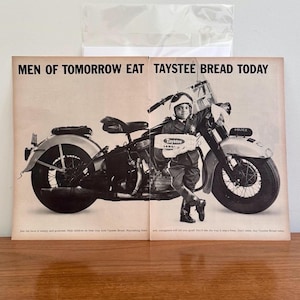 May include: A vintage black and white advertisement showing a child in a police uniform posing with a motorcycle. The ad promotes Taystee Bread with the slogan "MEN OF TOMORROW EAT TAYSTEE BREAD TODAY".