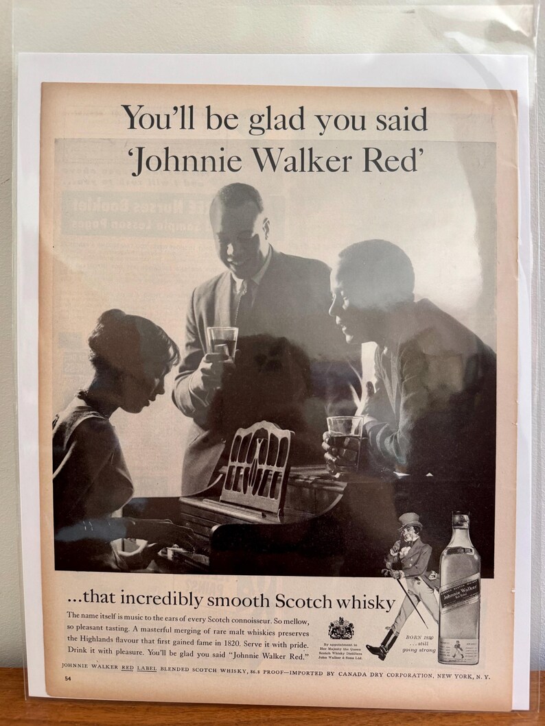 May include: Vintage advertisement for Johnnie Walker Red Label Scotch whisky. The black and white image shows three people enjoying drinks, with the text "You'll be glad you said 'Johnnie Walker Red'". A bottle and a drawing of a man are also featured.
