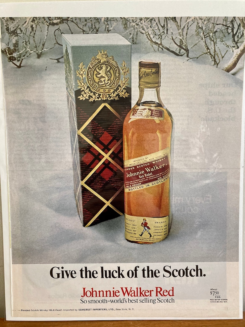 May include: A bottle of Johnnie Walker Red Label Scotch whisky with a red and white tartan box. The bottle is sitting on a snowy surface. The text on the bottle reads "Imported by Somerset Importers, Ltd., New York, N.Y. Blended Scotch Whisky, 86.8 Proof. Johnnie Walker Red Label. Bottled in Scotland."