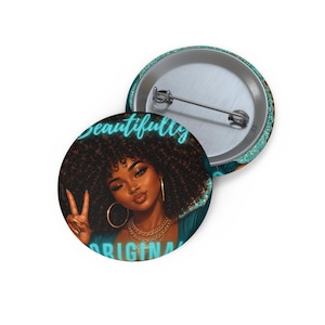 May include: Two round buttons with a teal and gold design. One button features a portrait of a woman with curly hair, gold jewelry, and the words "Beautifully Original" in teal script. The other button is plain.