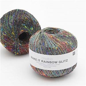 May include: Two skeins of rainbow colored yarn with silver glitter. The yarn is labeled "Make It Rainbow Glitz" and is a creative brand.