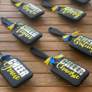 Perfect for competitions, pep rallies, or everyday use, our custom cheer team brushes are the ultimate expression of unity and pride.