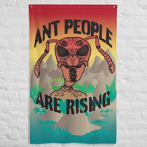 May include: A wall flag with a red, yellow, and blue gradient background. The flag displays a stylized ant-like creature with the text "ANT PEOPLE ARE RISING" in black. The ant has an intricate, decorative design.