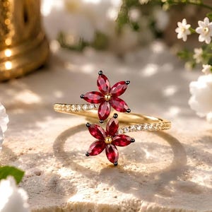 Anello in argento sterling 925 con rubino sintetico taglio marquise e design floreale.
