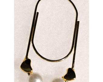 May include: Gold-tone earring with two white pearls and two heart-shaped charms.