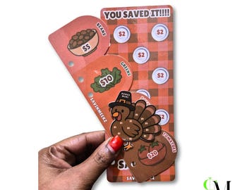 May include: A set of orange and brown plaid savings challenge trackers featuring illustrations of food items like beans, greens, and tomatoes with dollar amounts, plus a turkey character wearing a hat labeled bonus mini.