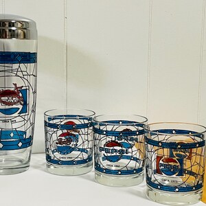 May include: A vintage Pepsi cocktail shaker and glasses set. The clear glass pieces feature a blue and white stained-glass design with the Pepsi logo and the text "Circa" followed by a year.