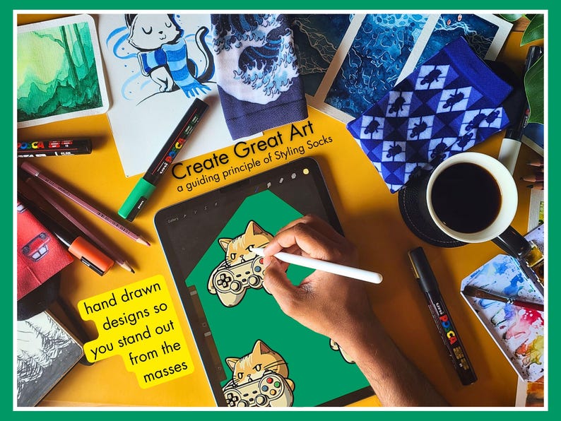 A photo of a man drawing the design for Novelty Gaming Cat Themed Socks in his creative studio