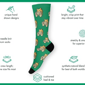 Novelty Gaming Cat Themed Socks showing the various features of the sock materials - including hand-drawn designs, 200 needle knit premium socks, stretchy and smooth fabric, bright crisp print that stay vibrant, and a cushioned heel & toe.
