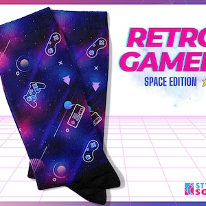May include: A pair of blue and purple socks with a space-themed design featuring a retro video game controller, stars, and planets. The socks have the text "Retro Gamer Space Edition" on them.