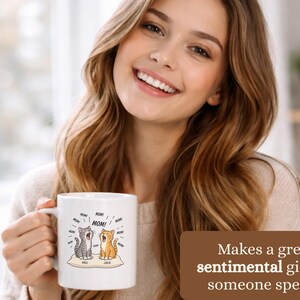 Woman holds mug with cats labeled "Milo" and "Jack" and "MOM!".