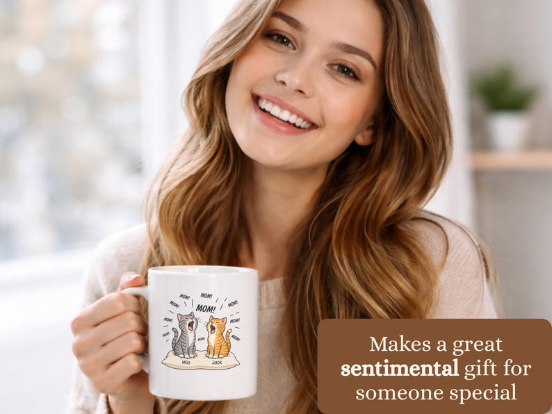 Woman holds mug with cats labeled "Milo" and "Jack" and "MOM!".