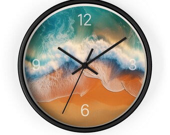 May include: Round wall clock with a black frame. The clock face features a beach scene with a turquoise ocean, white waves, and a sandy shore. Black clock hands point to the numbers 3, 6, 9, and 12.
