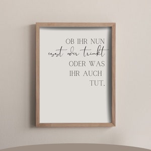 May include: A framed print with a white background and black text that reads "OB IHR NUN esst oder trinkt ODER WAS IHR AUCH TUT." The print is in a wooden frame and is available in A4 (21 x 29.7 cm) and A3 (29.7 x 42 cm) sizes.