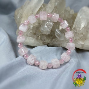 May include: A pink rose quartz bracelet featuring square-shaped beads. The bracelet is crafted from natural stones and is a lovely and delicate piece of jewellery.