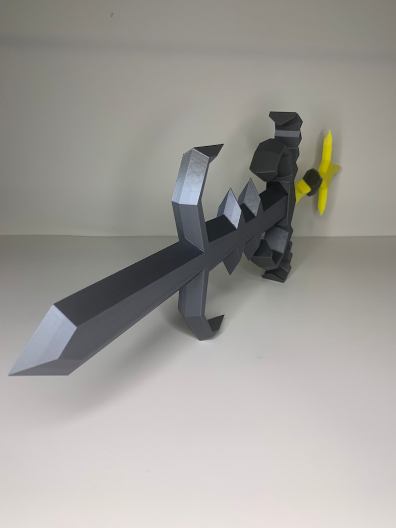 May include: A black and yellow 3D printed sword with a sharp point and a curved handle. The sword is made of multiple pieces that are connected together.
