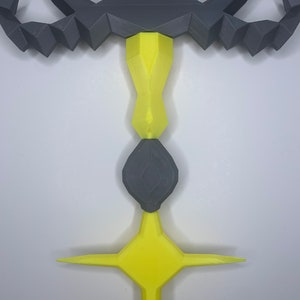 May include: A 3D printed sword with a black handle and a yellow star-shaped tip. The handle is decorated with a scorpion design.