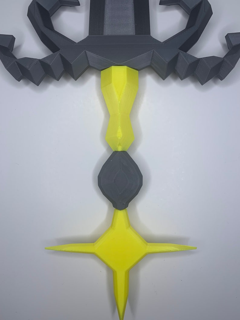 May include: A 3D printed sword with a black handle and a yellow star-shaped tip. The handle is decorated with a scorpion design.