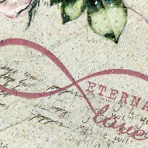 Puede incluir: Un s&iacute;mbolo de infinito rosa con la palabra "Eternal Love" impresa en negro sobre un fondo de tela beige con textura brillante.