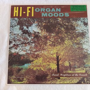 May include: Vintage vinyl record album cover titled "HI-FI ORGAN MOODS" with a scenic autumn landscape. The album features Frank Wrightson at the Console. The cover has a green, yellow, and brown color scheme.