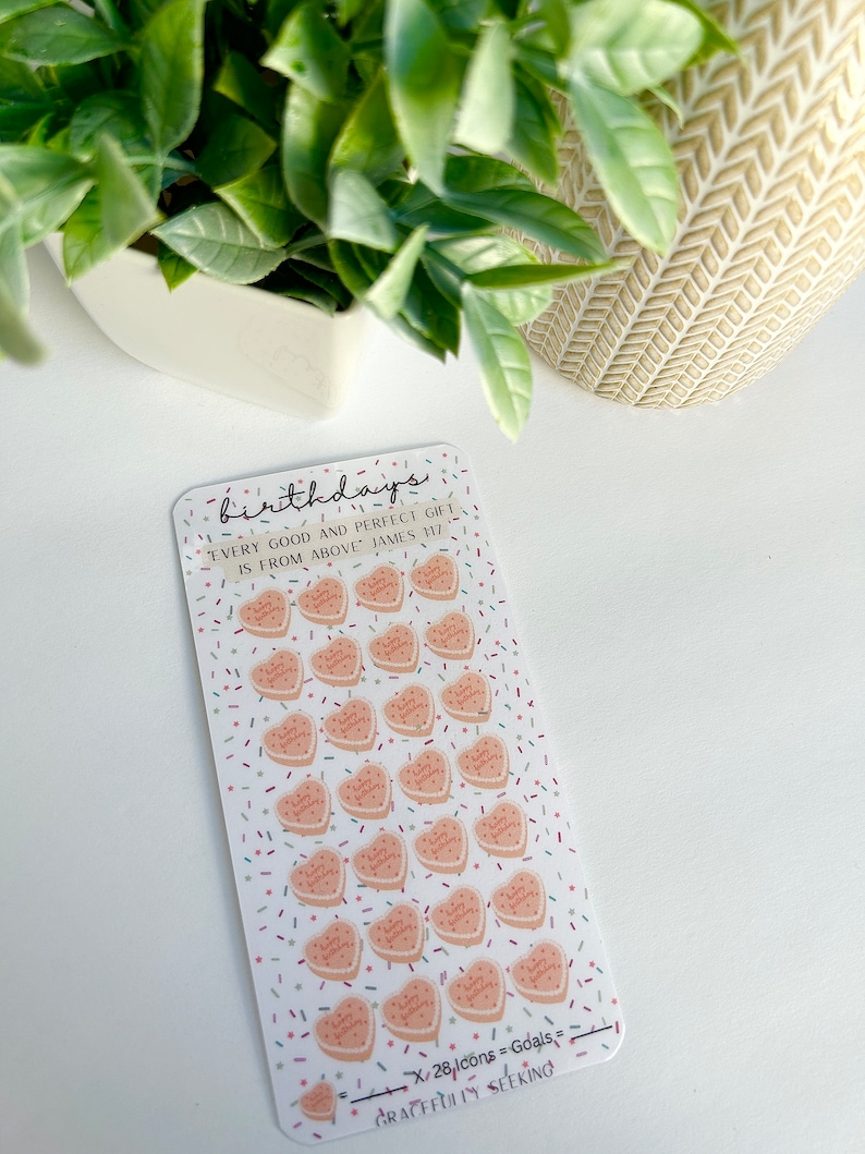 May include: A sheet of stickers with 28 pink heart-shaped stickers with the text "Happy Birthday" on each. The stickers are on a white background with confetti sprinkles. The text "Every good and perfect gift is from above James 1:17" is at the top of the sheet. The text "X/28 Icons = Goals" and "Gracefully Seeking" is at the bottom of the sheet.
