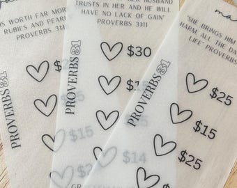 May include: Three white cards with black text and hearts. The cards are labeled "January", "February", and "March". Each card has a Bible verse and a price. The January card says "Is worth far more rubies and pearls" Proverbs 3:11. The February card says "The heart of her husband trusts in her and he will have no lack of gain" Proverbs 3:11. The March card says "She brings him harm, all the days of his life" Proverbs 31:11.