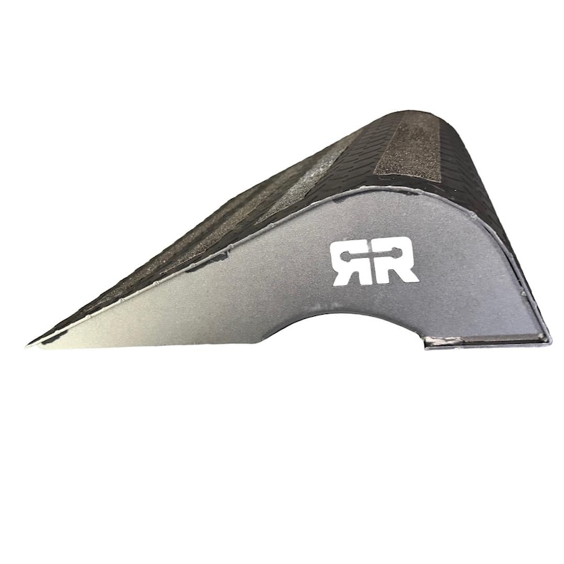 May include: A silver-colored automotive part with a curved, textured top and a cut-out section. The part has a white logo with the letters "RR" on its side. The object is designed for automotive use.