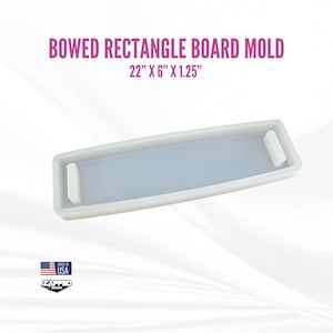 May include: White silicone mold for making a bowed rectangle board. The mold is 22 inches long, 6 inches wide, and 1.25 inches thick.