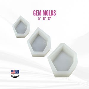 May include: Three white gem-shaped molds in varying sizes, 5", 6", and 8", are displayed against a white background. The text "GEM MOLDS" and size details are in pink. The image includes a "Made in USA" logo.