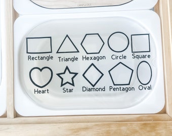 May include: White plastic tray with black outlines of various shapes, including a rectangle, triangle, hexagon, circle, square, heart, star, diamond, pentagon, and oval. Each shape has its name printed below it.