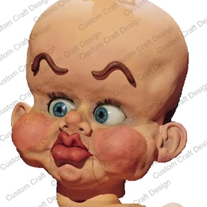 May include: A doll head with a bald, peach-colored head, large blue eyes, and exaggerated features. The doll has large, rosy cheeks, a prominent red mouth, and brown eyebrows. The text "Custom Craft Design" is repeated around the image.