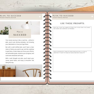 May include: A pink and brown journal with the title "Plan to Succeed: Career Clarity Journal" on the cover. The journal has a spiral binding and is open to a page with the text "Plan to Succeed" and prompts for career planning.