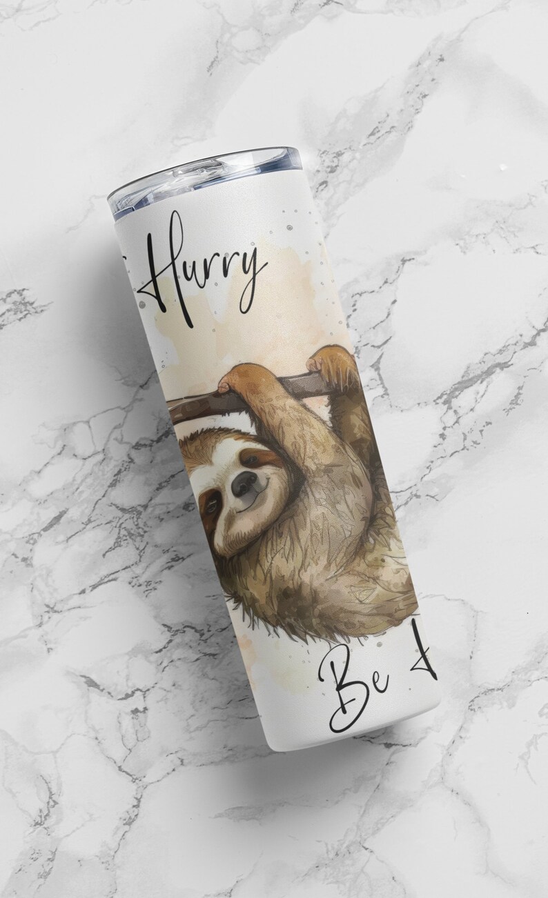 May include: White stainless steel tumbler with a sloth hanging from a branch. The tumbler has the text "Hurry Be 4" printed on it.