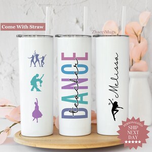May include: Three white stainless steel tumblers with a straw. The tumbler on the left has a silhouette of dancers. The middle tumbler has the word "DANCE" in colorful letters with the words "teacher" written vertically. The tumbler on the right has the name "Melissa" written vertically with a silhouette of a dancer.