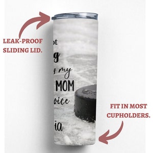 May include: White stainless steel tumbler with a black hockey puck and the text "Not my mom's choice" on a white background. The tumbler has a leak-proof sliding lid and fits in most cupholders.