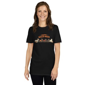May include: A black short-sleeve t-shirt featuring a graphic of five dachshunds in various Halloween costumes. Above the dogs, the text reads HAPPY HALLO-WEEN in orange letters. The dogs are dressed as a mummy, a witch, a vampire, a pumpkin, and a ghost.