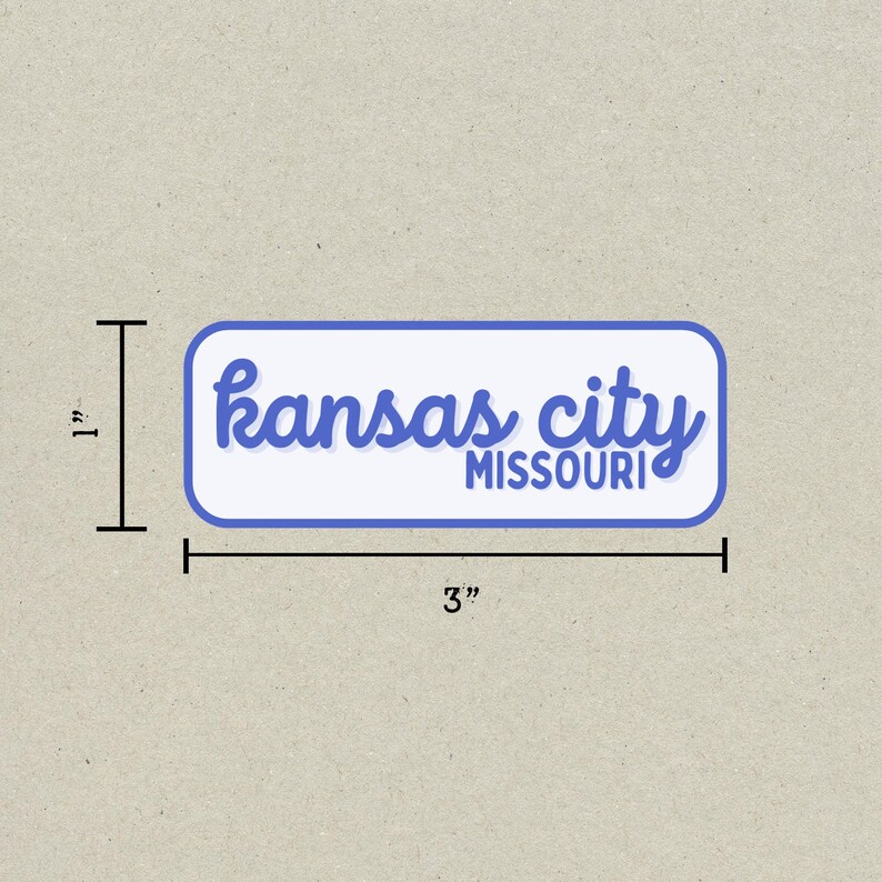 May include: A rectangular sticker with rounded corners, featuring the words "Kansas City MISSOURI" in blue script and block letters on a white background. The sticker measures 3 inches long and 1 inch high.