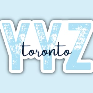 May include: A blue sticker with the letters YYZ and the word "toronto" in white lettering.