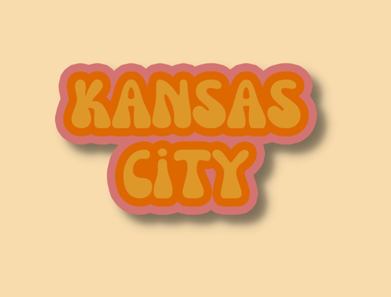 May include: A retro-style graphic design with the text "KANSAS CITY" in orange letters with a pink outline.