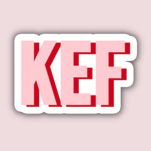 May include: A sticker with the word "KEF" in red letters with a pink outline.