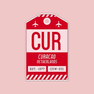 May include: Red luggage tag with white text that reads "CUR" for Curacao, Netherlands. The tag also includes the text "EST. 1977" and "CUW-531".