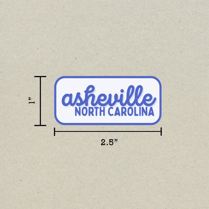 May include: A rectangular sticker with rounded corners, measuring 2.5 inches wide and 1 inch tall. The sticker features the word "asheville" in blue script above "NORTH CAROLINA" in blue block letters, all on a white background with a blue border.