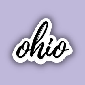 May include: A black and white sticker with the word "Ohio" written in a cursive font.