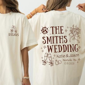 two women wearing white t-shirts with text and graphics printed on them.