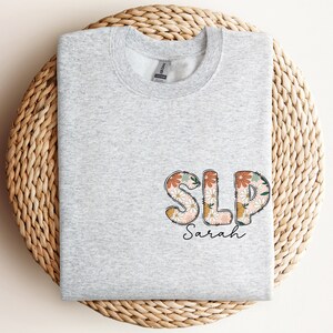 a t - shirt with the word slp on it