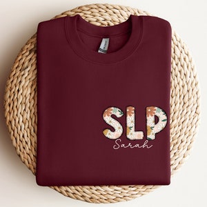 a red shirt with the word slp on it