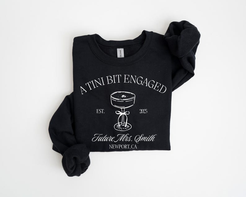 A black t-shirt with white text and graphics printed on it.
